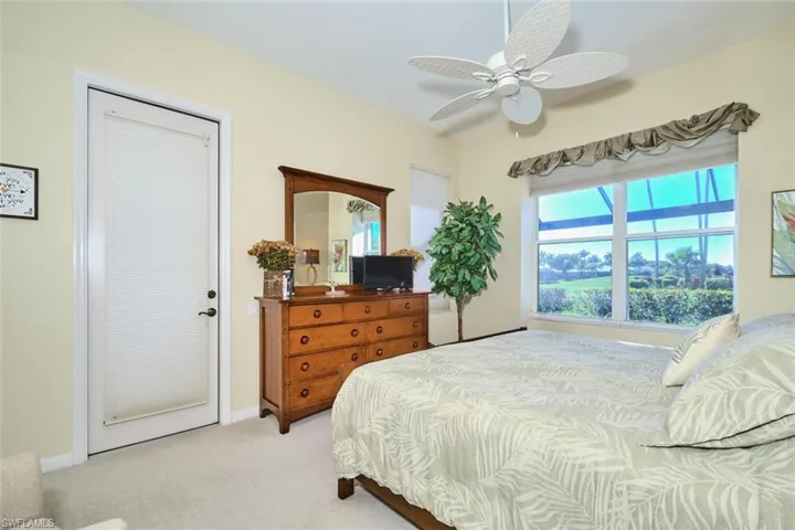 Bedroom with light carpet and ceiling fan