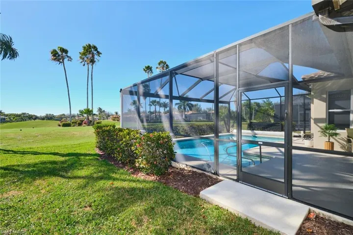 Outdoor pool with a lawn, a lanai, a sunroom, and a patio