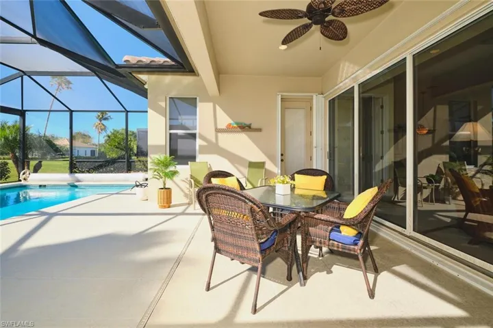 View of patio / terrace featuring outdoor dining area, a sunroom, ceiling fan, a lanai, and an outdoor pool