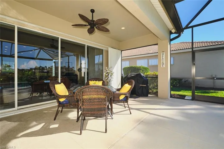 Sunroom / solarium with ceiling fan, outdoor dining space, and a patio area