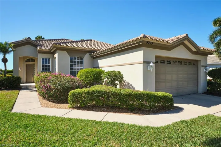 Mediterranean / spanish-style home featuring an attached garage, stucco siding, driveway, and a tiled roof