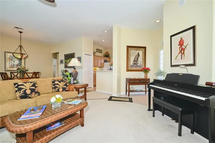 Living area featuring light carpet and recessed lighting