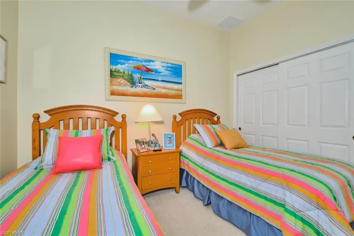 Bedroom with a closet and light carpet