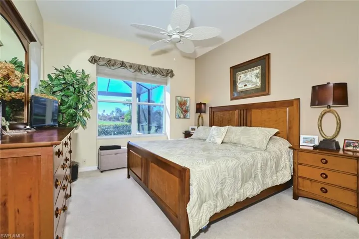 Bedroom with light carpet and a ceiling fan