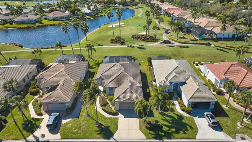 Aerial perspective of suburban area with a local golf course and a nearby body of water