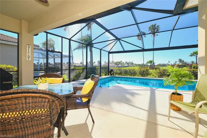 Outdoor pool featuring a sunroom, a lanai, a patio, area for grilling, and outdoor dining area
