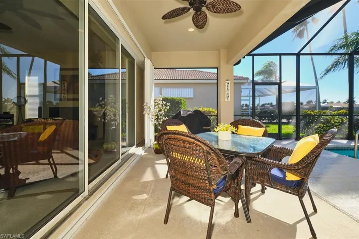 Sunroom with a ceiling fan, outdoor dining space, and a patio area