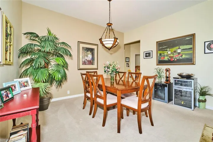 Dining area with light carpet and baseboards
