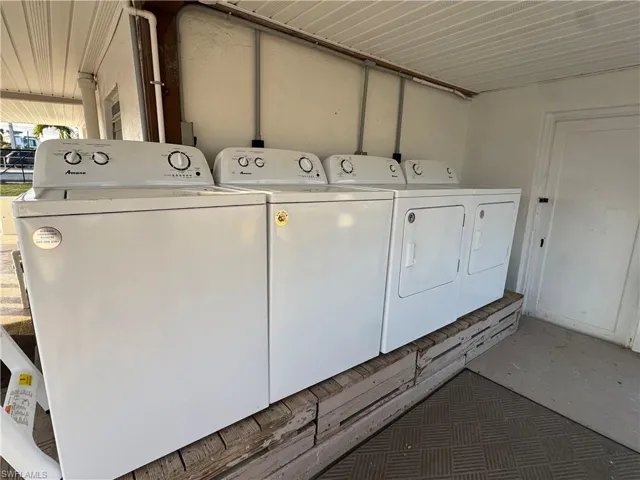 Laundry room with independent washer and dryer and concrete floors
