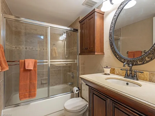 Full bathroom featuring combined bath / shower with glass door,  and vanity