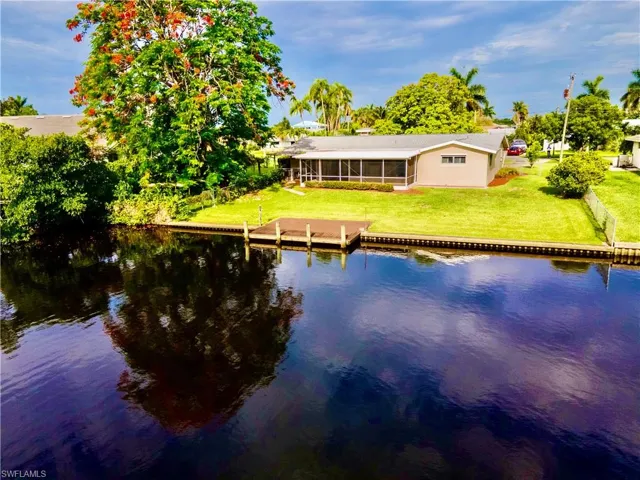 Waterfront property featuring a private dock, screened lanai