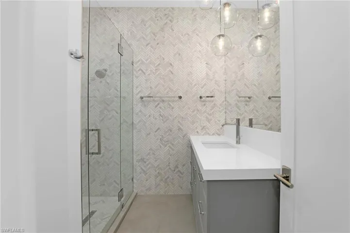 Bathroom with vanity and a shower stall