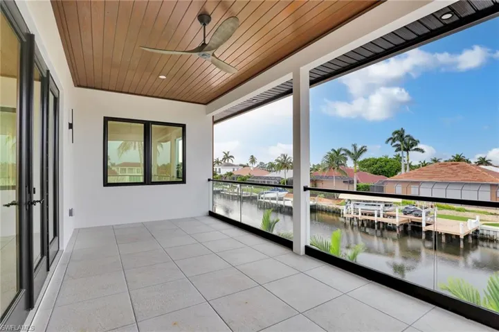 Balcony with a water view and a ceiling fan
