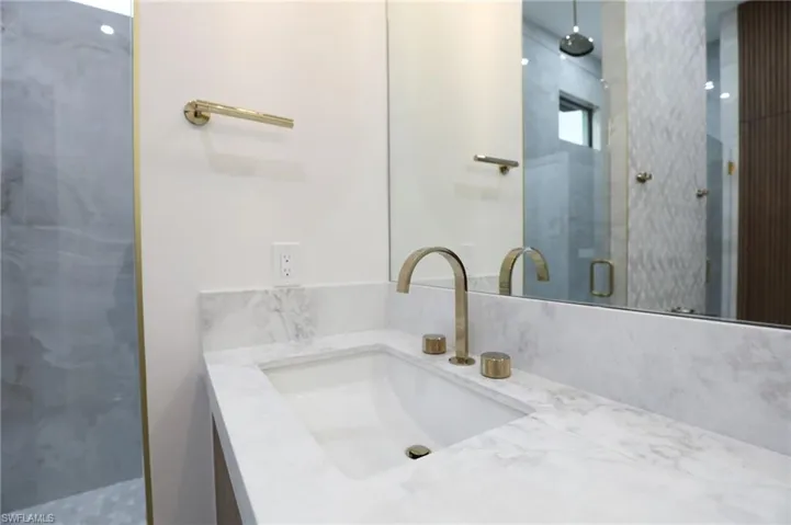 Full bath with a stall shower and vanity