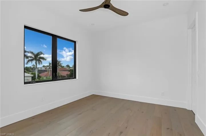 Spare room featuring light wood finished floors and a ceiling fan