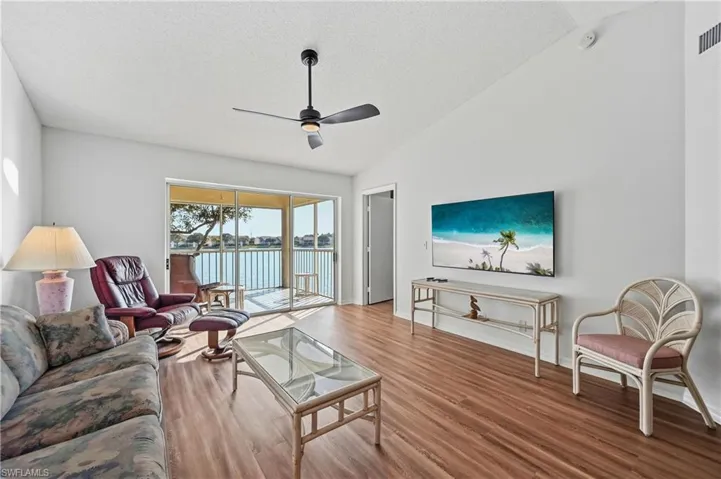 Living room featuring wood finished floors and a ceiling fan