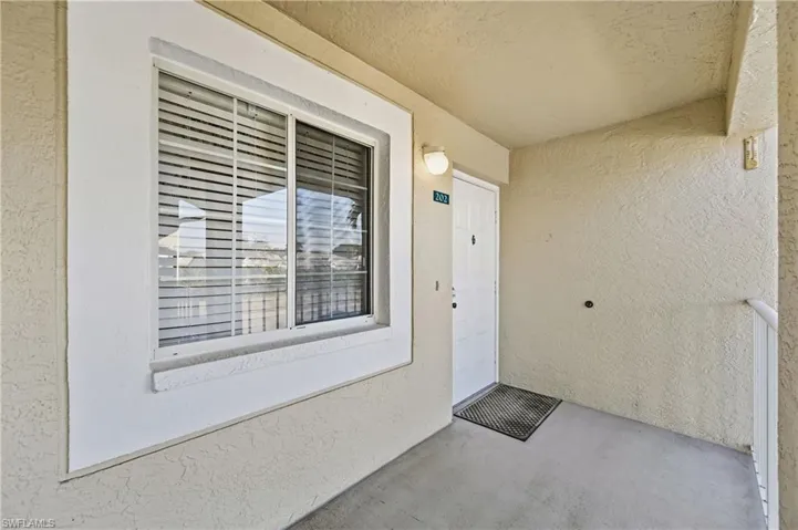 Entrance to property featuring stucco siding