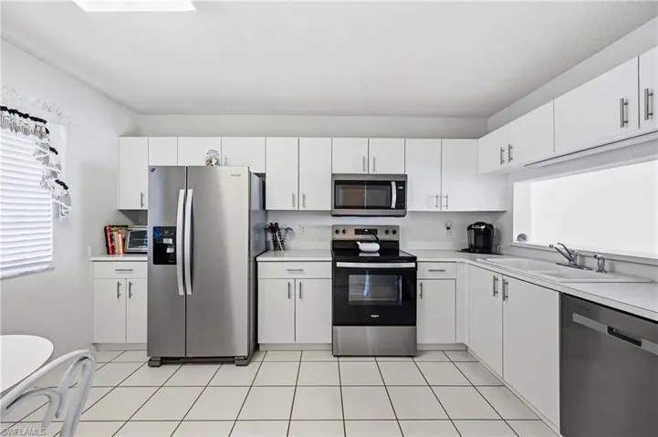Kitchen with stainless steel appliances, plenty of natural light, and light countertops