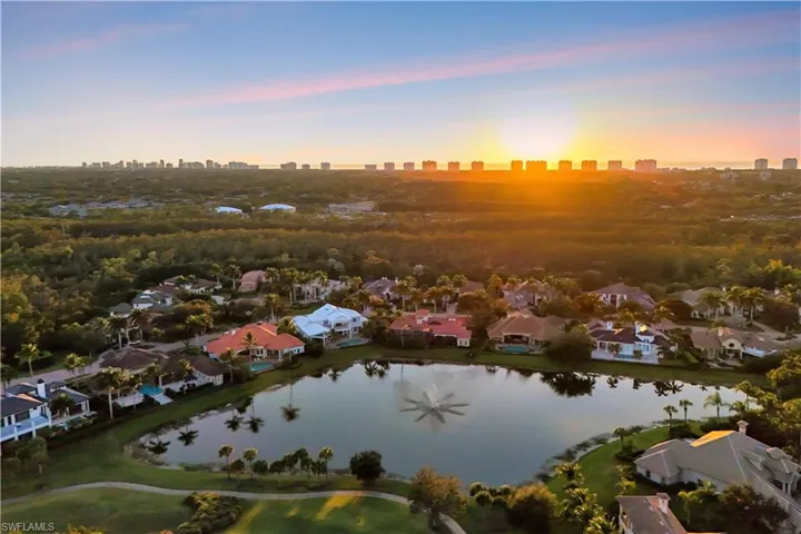 Aerial view at dusk of a water view, a residential view, and a skyline view