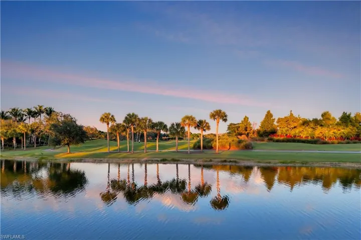 Water view with a tree filled landscape and private Pelican Marsh golf course