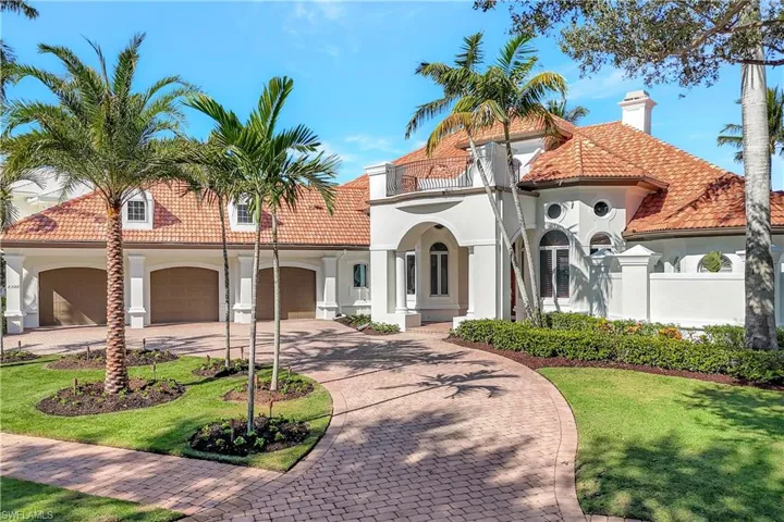 Mediterranean house with stucco siding, decorative driveway, and a front yard