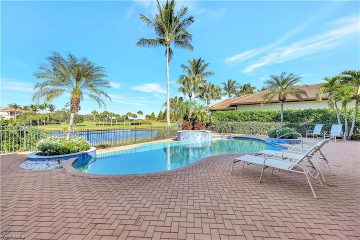 View of pool with a patio area, a pool with connected hot tub, and a water view