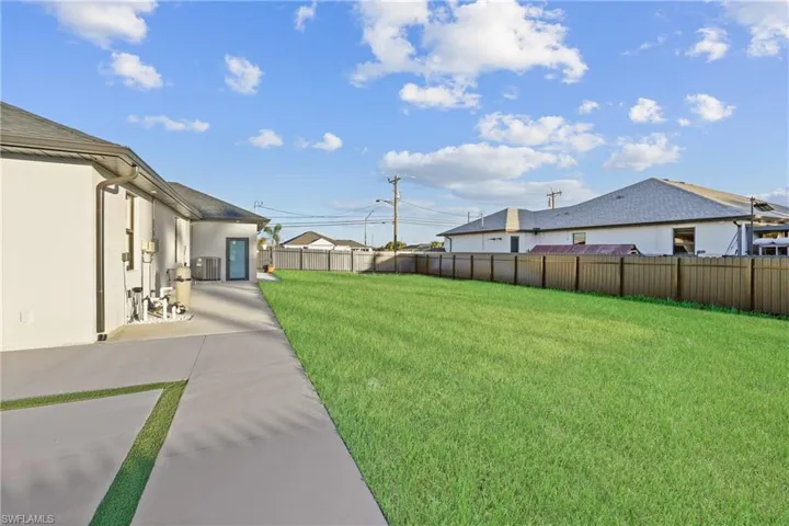 View of yard with a patio and central AC unit