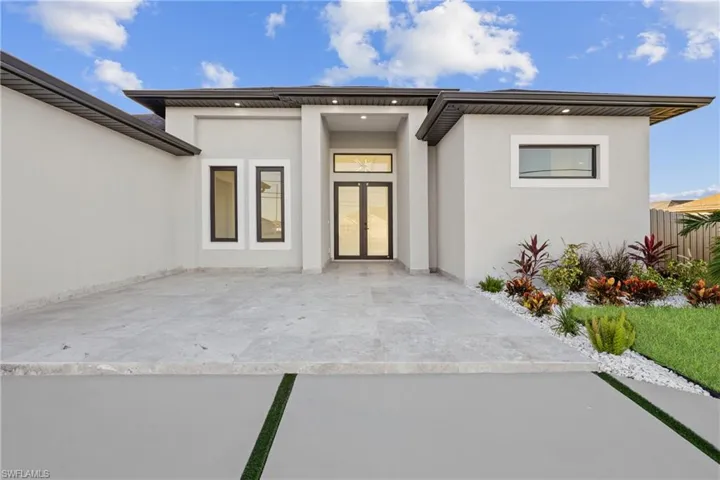 Entrance to property featuring french doors and a patio