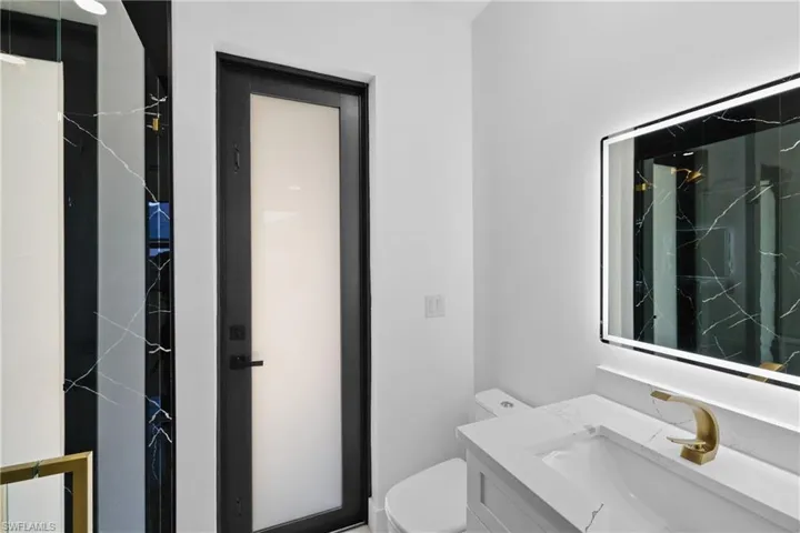 Bathroom featuring vanity, toilet, and walk in shower