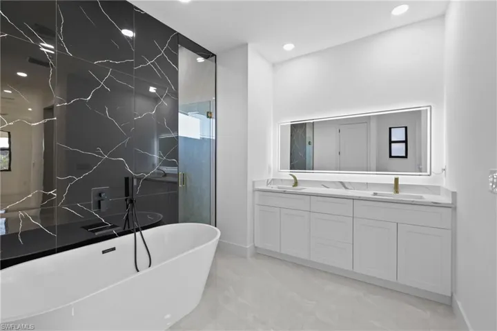 Bathroom featuring plus walk in shower and vanity