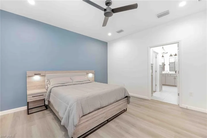 Bedroom with visible vents, baseboards, and light wood-type flooring