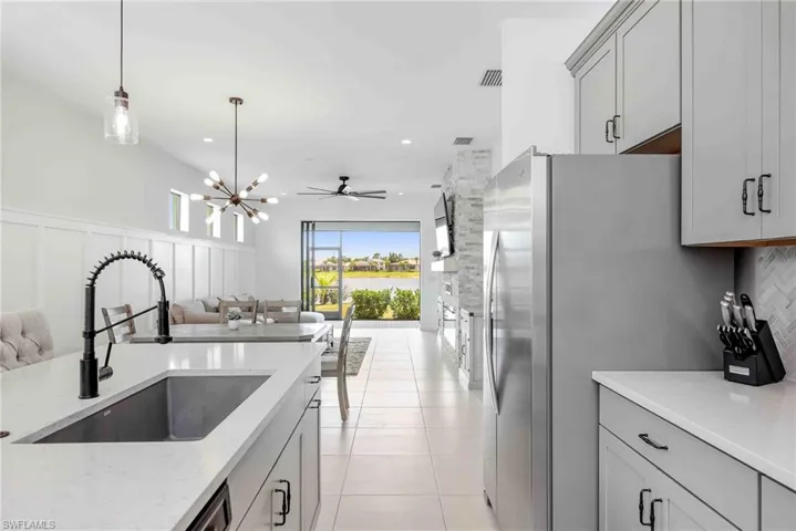 Kitchen featuring gray cabinets, a sink, and appliances with stainless steel finishes