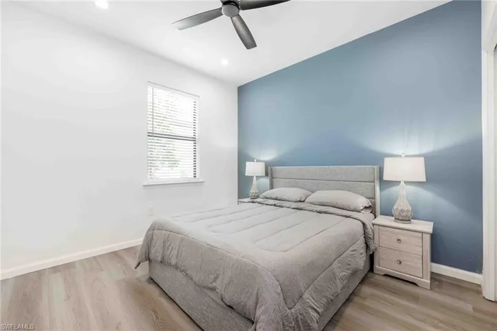 Bedroom featuring light wood finished floors, baseboards, a
