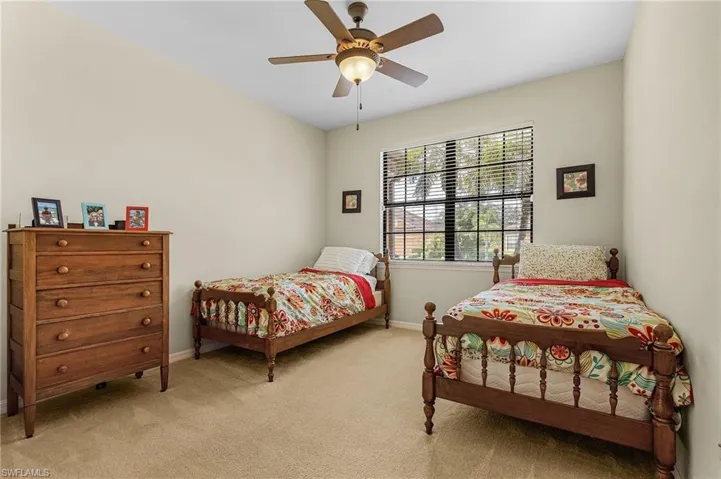 Bedroom featuring ceiling fan and light colored carpet