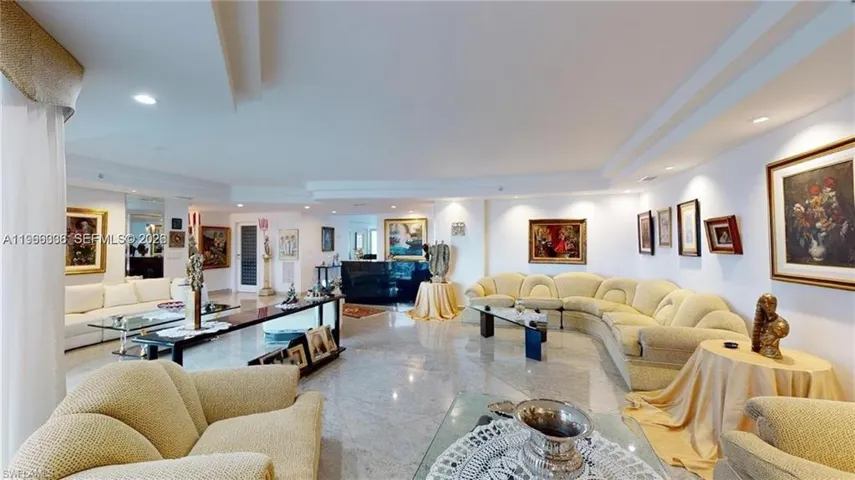 Living room featuring recessed lighting and a raised ceiling