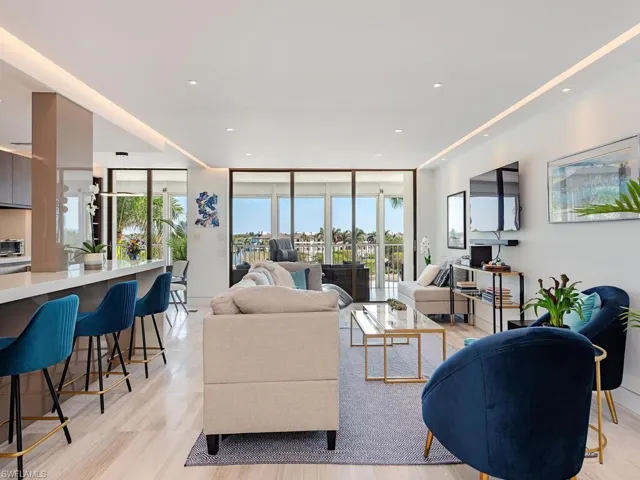 Living room featuring recessed lighting, floor to ceiling windows, and light wood finished floors