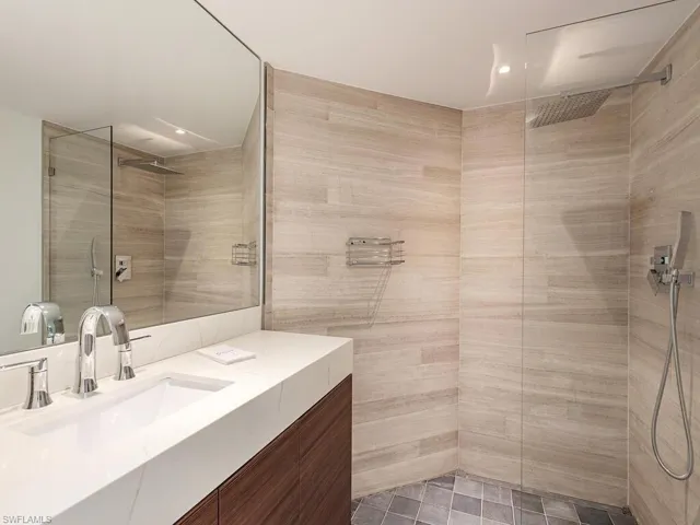 Full bath with vanity and tiled shower