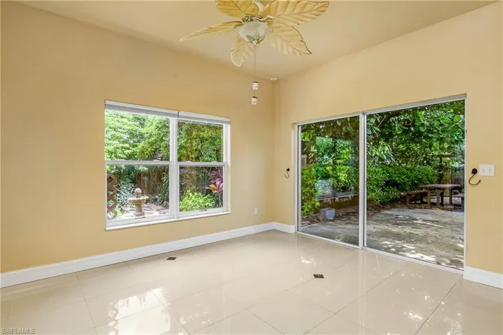 Spare room featuring ceiling fan and light tile patterned floors