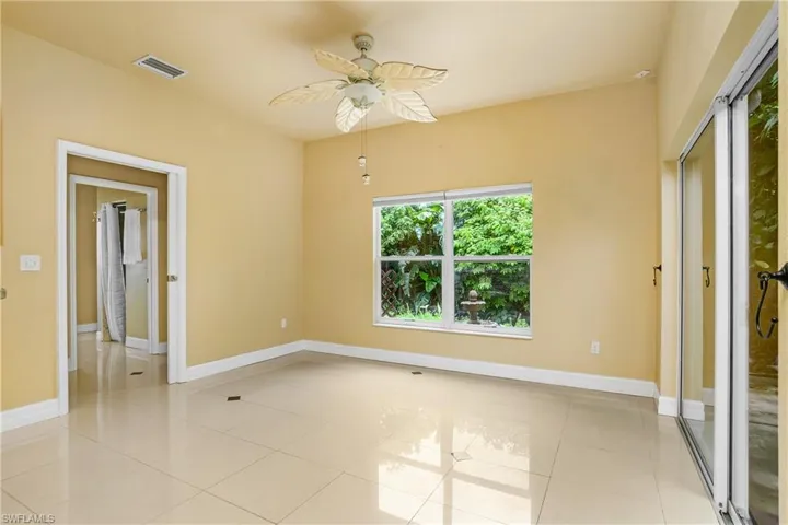 Unfurnished bedroom with ceiling fan and light tile patterned floors