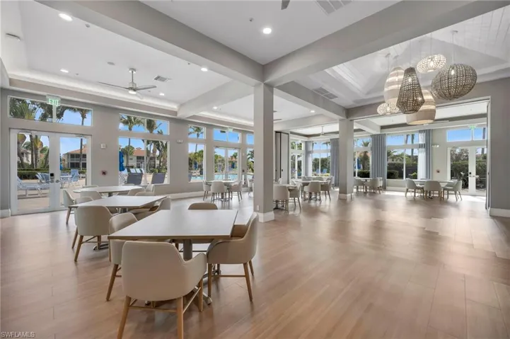 Dining area featuring french doors, ceiling fan, light wood-style flooring, recessed lighting, and a high tray ceiling