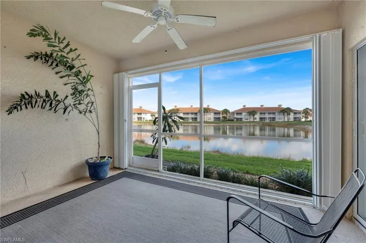 Unfurnished sunroom featuring a water view and a residential view
