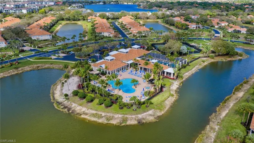 Aerial view of property and surrounding area featuring a nearby body of water