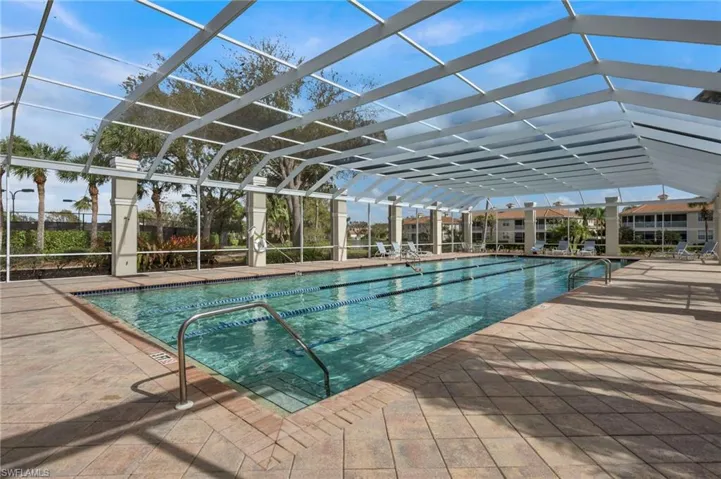 Community pool with a lanai, a patio area, and a sunroom
