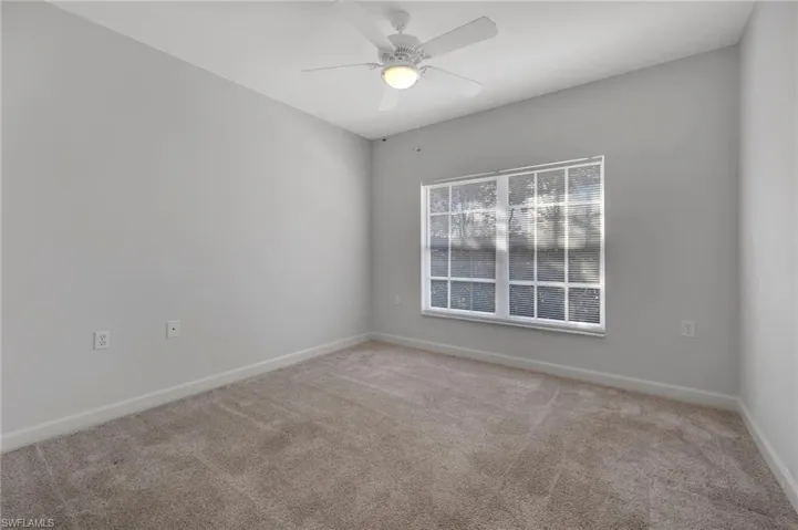 Spare room with carpet floors and ceiling fan