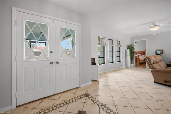 Entryway featuring double doors with decorative glass inserts