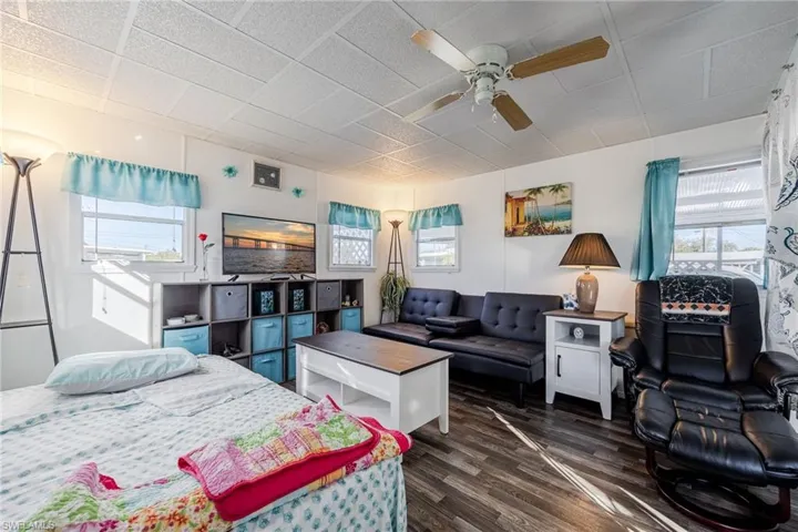 Bedroom with dark wood finished floors and ceiling fan