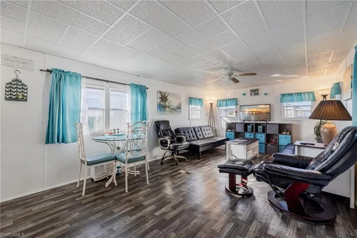 Sitting room with plenty of natural light, ceiling fan, and wood finished floors
