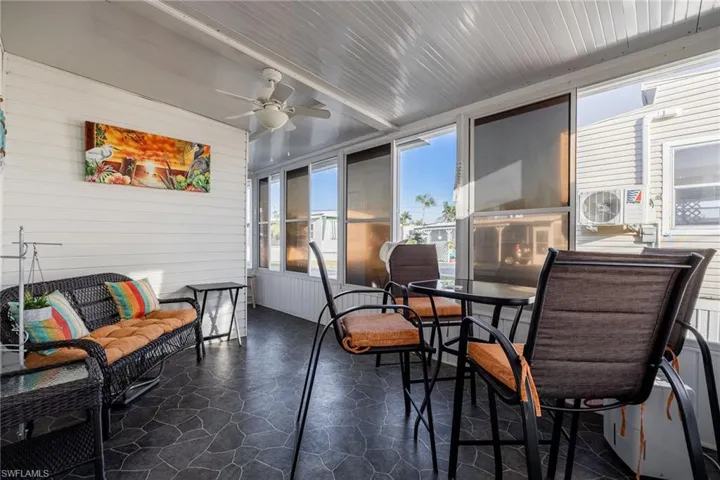 Sunroom featuring cooling unit and a ceiling fan