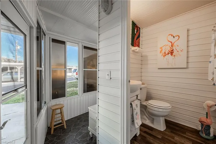 Half bath with wooden walls and toilet
