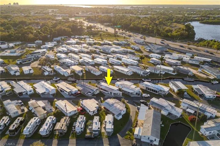 Birds eye view of property with a water view